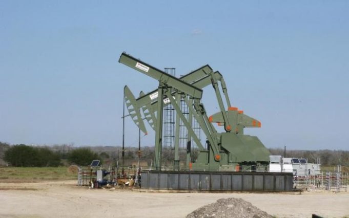 A pump jack used to help lift crude oil from a well in South Texas’ Eagle Ford Shale formation stands idle in Dewitt County Texas