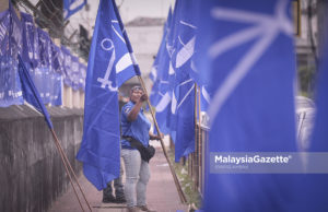 Penduduk, Noraliza Ismail, 38, melakukan kerja-kerja pemasangan bendera Barisan Nasional (BN) sempena Pilihan Raya Umum ke-14 (PRU-14) di hadapan PPR Perkasa, Jalan Nakhoda Yusof, Kuala Lumpur