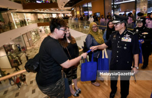 Ketua Polis Kuala Lumpur, Datuk Seri Mazlan Lazim (kanan) memberi penerangan kepada pengunjung sambil mengedarkan risalah pada Program Walkabout Pencegahan Jenayah Polis Kuala Lumpur sempena Pilihan Raya Umum ke-14 (PRU14) di pusat membeli belah MyTown, Kuala Lumpur. foto FAREEZ FADZIL, 06 MEI 2018.