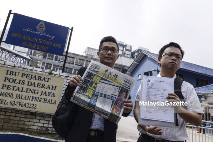 Pegawai Tugas-Tugas Khas kepada Menteri Pengangkutan, Chung Yi Fan (kanan) dan Setiausaha Akhbar kepada Menteri Pengangkutan, Lim Swee Kuan (kiri) menunjukkan laporan polis yang dibuat mengenai isu pihak yang menawarkan lesen terbang kepada orang awam melalui media sosial di Ibu Pejabat Polis Daerah Petaling Jaya, Petaling Jaya. foto AFIQ RAZALI, 22 JUN 2018.