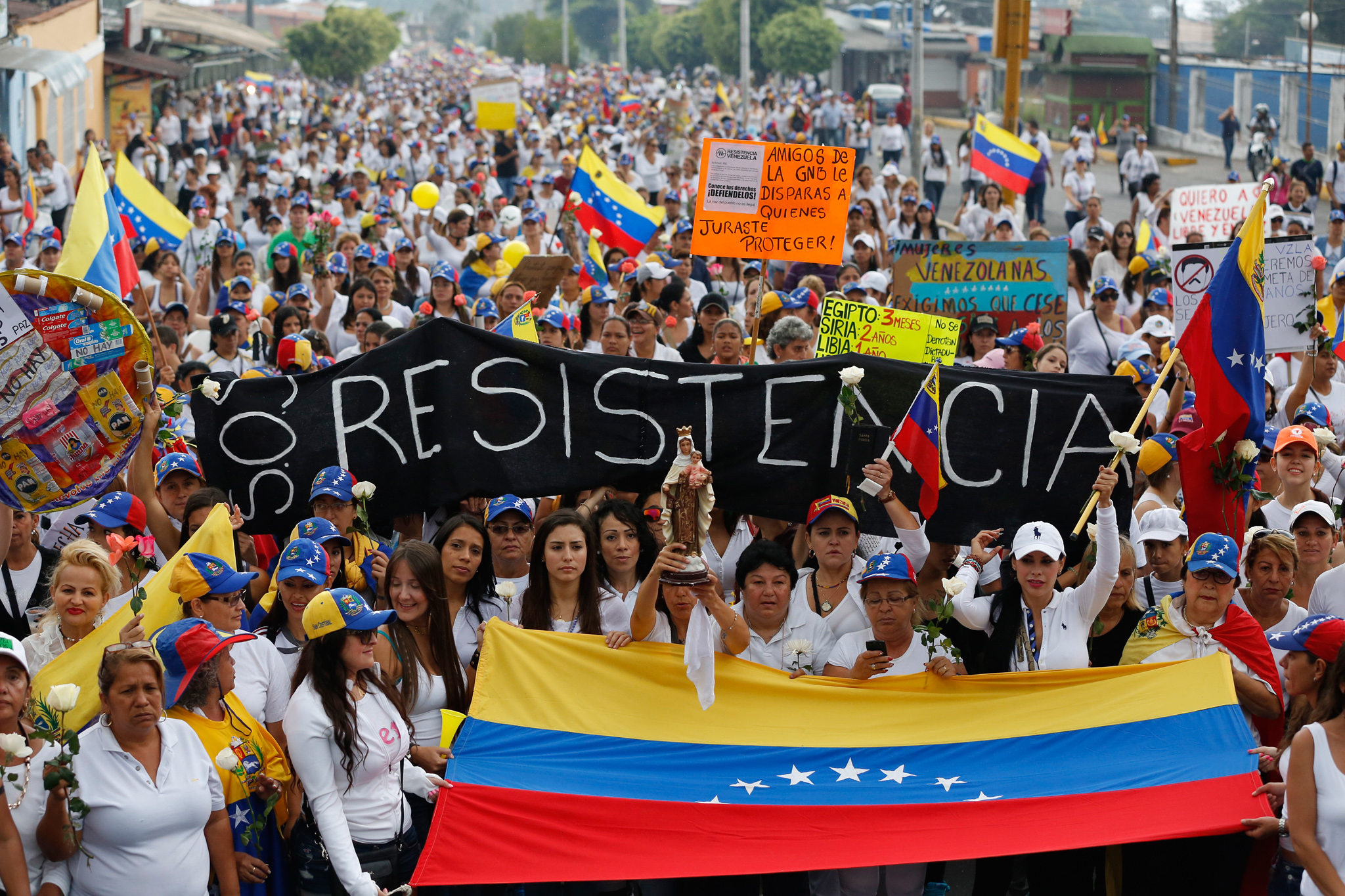 Opposition demonstrators take part in a women’s rally against Nicolas Maduro’s government in San Cristobal