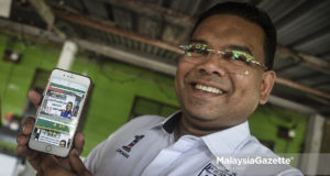 Calon Barisan Nasional untuk Pilihan Raya Kecil Sungai Kandis, Datuk Lokman Noor Adam menunjukkan poster kempen beliau yang diarahkan turun oleh pihak Suruhanjaya Pilihan Raya (SPR) pada Program Ziarah Kasih sempena kempen Pilihan Raya Kecil N. 49 Sungai Kandis di Lorong Abdullah, Batu 7, Jalan Kebun, Shah Alam, Selangor. foto AFFAN FAUZI, 30 JULAI 2018