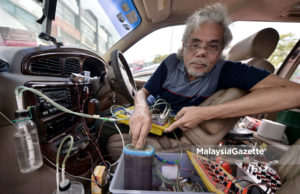Abdul Hamid Yeop Zainuddin menunjukkan prototaip sistem penggunaan air yang dapat menjimatkan penggunaan petrol pada sesebuah kenderaan di Pejabat Malaysia Gazette. foto IQBAL BASRI.