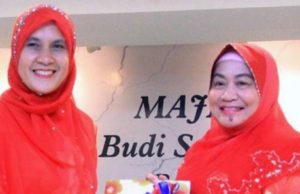 Dr. Aishah (kanan) menyerahkan tugas kepada Yang Dipertua Kasih yang baharu, Sohadah.