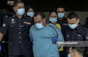 The two suspects, Mohd. Fadzli Abdull Razak (stepfather) and Zuraida Atan (mother) are escorted by the police from the Melaka Criminal Investigation Department (CID) to the Ayer Keroh Courts Complex to face charges for murdering and abusing Zubaidi Amir Qusyairi Abd. Malek. PIX: AFFAN FAUZI / MalaysiaGazette / 10 FEBRUARY 2021