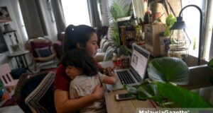 Digital Marketing Officer, Nadia Ismail, working from home in Ampang, Selangor, while taking care of her son, Mohd Aidan Soliano Dinie Soliano following the Conditional Movement Control Order (CMCO). PIX: AFIQ HAMBALI / MalaysiaGazette / 06 NOVEMBER 2020