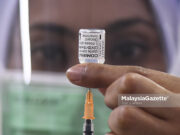 senior citizens second booster dose Malaysia adult Covid-19 vaccination children (Picture for representational purposes only). A healthcare worker preparing the Pfizer - BioNTech Covid-19 vaccine shots for the National Covid-19 Immunisation Programme (PICK) at MAEPS Serdang, Selangor. PIX: SYAFIQ AMBAK / MalaysiaGazette / 05 MARCH 2021. US FDA approves children 5 years-old