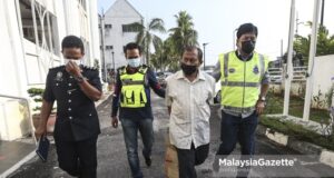 A suspect of the murder case of the IKRAM’s Advocacy Department Manager is charged at the Kajang Court in Selangor. PIX: SYAFIQ AMBAK / MalaysiaGazette / 19 MARCH 2021