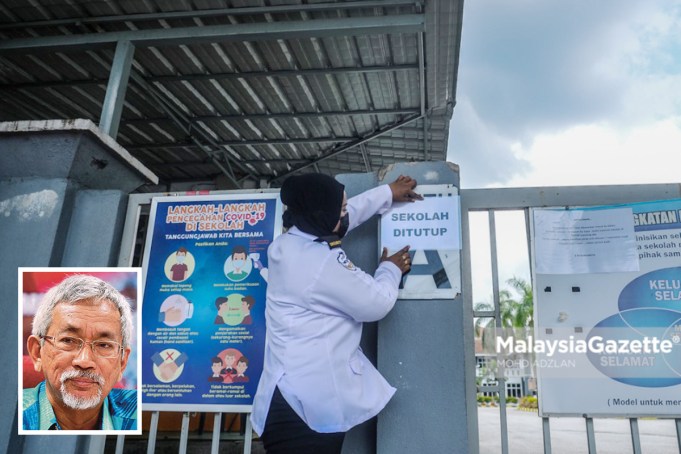 Security guard, Jamalina Mohammad Ibrahim, 38, putting up a notice on school closure at Sekolah Menengah Kebangsaan Seksyen 7, Shah Alam after the emergence of Covid-19 pandemic cluster that forced the closure of 19 schools in Selangor. PIX: MOHD ADZLAN / MalaysiaGazette / 20 APRIL 2021. Picture in frame: Associate Professor Dr Mohamad Ali Hasan.