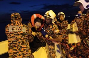 The Fire and Rescue Team saving a man who is trying to attempt suicide by jumping off the Penang Bridge into the sea. suicide Penang Bridge