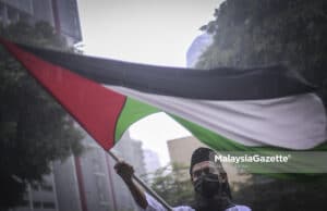 Israel crimes against humanity Palestine (Picture for representational purposes only.) A protestor flying the Palestine flag during the protest against the cruelty of Israel towards the Palestinians. PIX: HAZROL ZAINAL / MalaysiaGazette / 17 MAY 2021. war crime Gaza