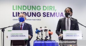 Minister of Health Datuk Seri Dr Adham Baba (left) and the Minsiter of Science, Technology and Innovation cum the Coordinating Minister of the National Covid-19 Immunisation Programme (PICK), Khairy Jamaluddin Abu Bakar at a joint-news conference full scale MCO Selangor