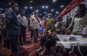Presiden PKR, Datuk Seri Anwar Ibrahim sempat beramah mesra dengan penerima vaksin ketika memantau pelaksanaan proses vaksinasi di Pusat Pemberian Vaksin (PPV) Sunway Pyramid, Selangor. Foto HAZROL ZAINAL, 28 MEI 2021.