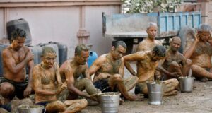 People apply cow dung on their bodies during "cow dung therapy" believing it will boost their immunity to defend against the coronavirus disease (COVID-19) at the Shree Swaminarayan Gurukul Vishwavidya Pratishthanam Gaushala or cow shelter on the outskirts of Ahmedabad, India, May 9, 2021. REUTERS/Amit Dave Covid-19 cure