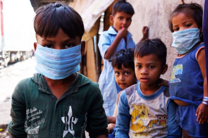 Sanjeev with face mask and other children on street
