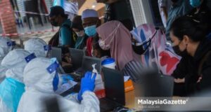 Individuals suspected to be positive of Covid-19 register themselves at the Covid-19 Assessment Centre (CAC) at the Port Klang Multipurpose Hall for their health assessment. PIX: MOHD ADZLAN / MalaysiaGazette / 01 AUGUST 2021