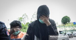 Ieda Nor Esbi Baharuddin, 35, (second right) and her boyfriend (red t-shirt), 34 are brought to the Bandar Baru bangi Court in Selangor to face charges for abusing and causing the death her 3-year-old son. PIX: HAZROL ZAINAL / MalaysiaGazette / 10 SEPTEMBER 2021