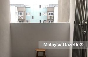 The stool and slippers left behind by the woman who jumped off the 13th floor of Pangsapuri Hijau Indah in Mak Mandin, Penang.