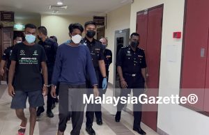 construction worker Bangladeshi murder girlfriend killing Indonesian woman Apartment Sri Nipah Kamruzzaman (blue shirt) was charged with the murder of his girlfriend at the George Town Magistrate Court today.