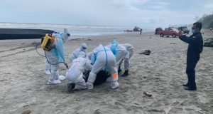 The search and rescue team carrying the dead body of one of the illegal immigrants who drowned after their boat capsized in the waters of Tanjung Balau, Johor.