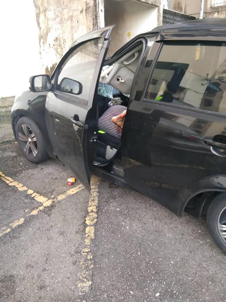 The dead body of the senior citizen was found in a black car parked at the flat in Cheras.  PIX: Courtesy of the Cheras District Police Headquarters