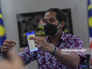 Khairy Jamaluddin Covid-19 vaccination status vaccine defamation suit Lokman Adam Ustaz Abu Syafiq