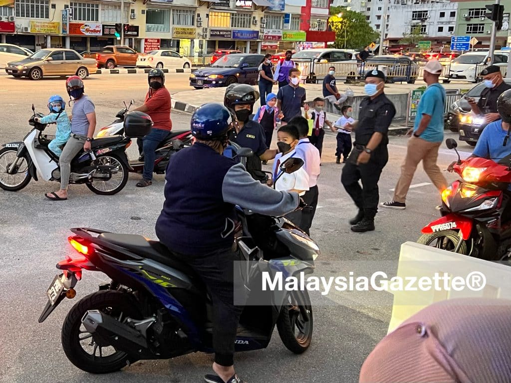 Parents sending their children for the physical school session today at Seri Relau, Penang.