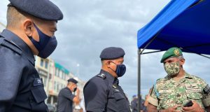 Kamarul Zaman Mamat (centre) is being briefed by the Iskandar Mersing Camp 21st Special Service Group General Staff Chief Aid Ridzwan Abdullah on the search and rescue mission of the four missing divers at Tokong Sanggol Island in Mersing, Johor. dive boat skipper