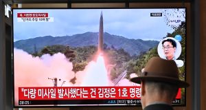 A man watches a television screen showing a news broadcast with file footage of a North Korean missile test, at a train station in Seoul on May 30, 2024. North Korea fired a salvo of short-range ballistic missiles early May 30, Seoul's military said, hours after Pyongyang sent hundreds of trash-filled balloons across the border to punish South Korea. (Photo by Jung Yeon-je / AFP)