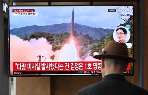 A man watches a television screen showing a news broadcast with file footage of a North Korean missile test, at a train station in Seoul on May 30, 2024. North Korea fired a salvo of short-range ballistic missiles early May 30, Seoul's military said, hours after Pyongyang sent hundreds of trash-filled balloons across the border to punish South Korea. (Photo by Jung Yeon-je / AFP)