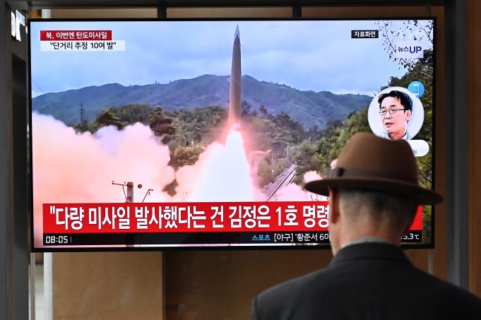 A man watches a television screen showing a news broadcast with file footage of a North Korean missile test, at a train station in Seoul on May 30, 2024. North Korea fired a salvo of short-range ballistic missiles early May 30, Seoul's military said, hours after Pyongyang sent hundreds of trash-filled balloons across the border to punish South Korea. (Photo by Jung Yeon-je / AFP)