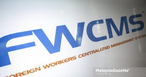 Logo Sistem Pengurusan Berpusat Pekerja Asing (FWCMS) di Cyberjaya. Foto HAZROL ZAINAL, 20 APRIL 2022.